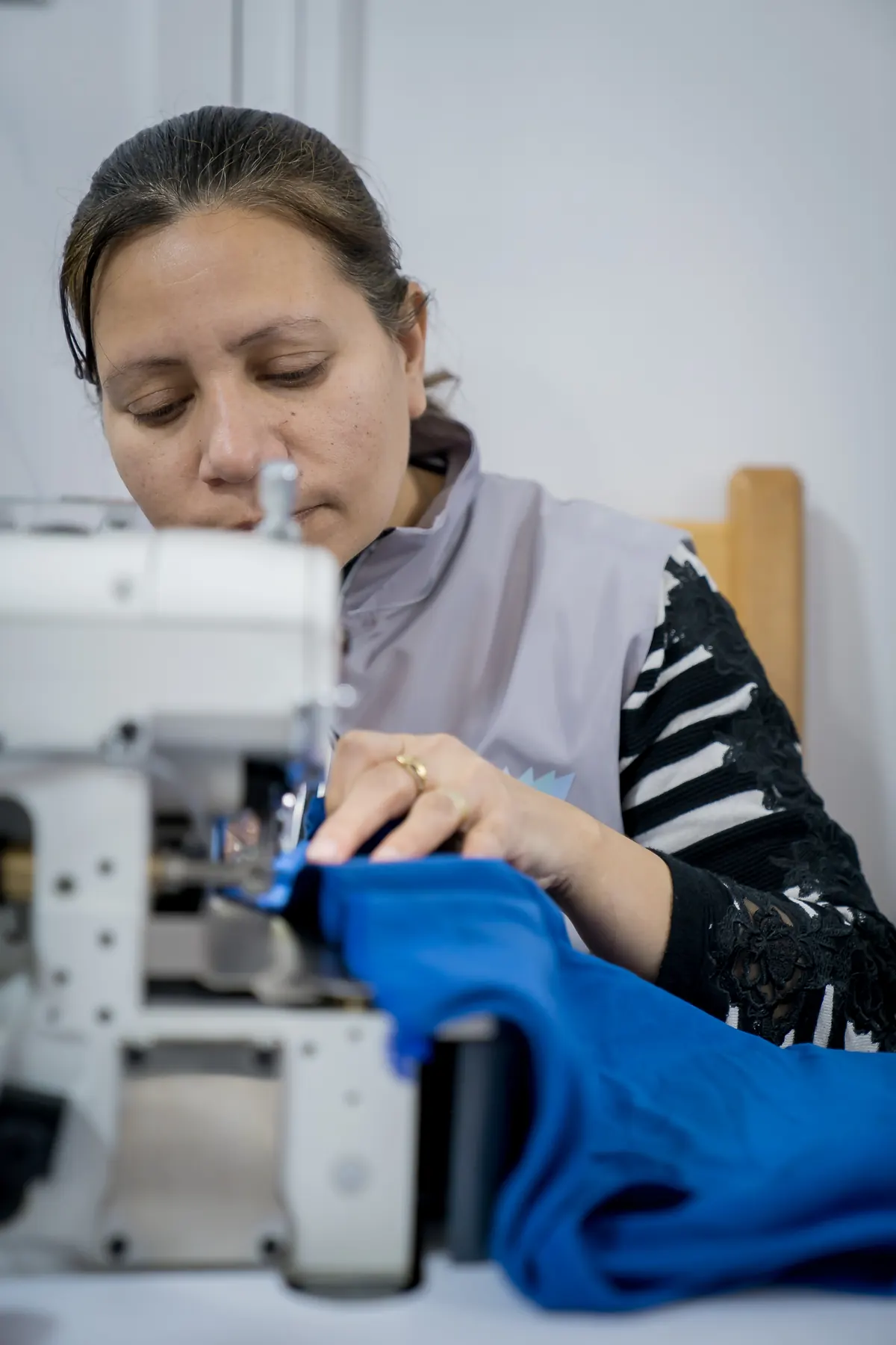 A seamstress at an industrial sewing machine